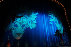 Masquerade masks on purple curtain of Stardust Theater Norwegian Gem.jpg