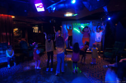 Dora and Norwegian Gem youth staff dance at Norwegian Gem Bliss Ultra Lounge.jpg